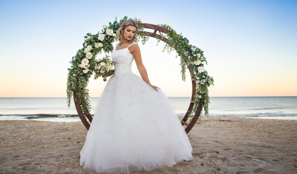 Bride in front of circular arbor