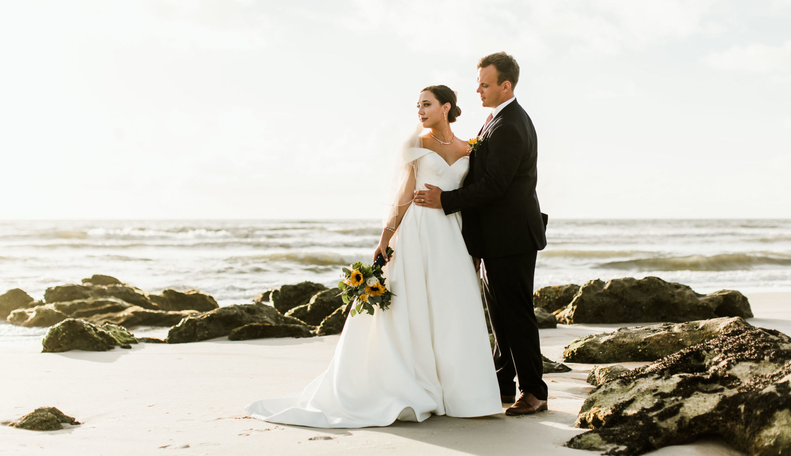 bride and groom beach rocks